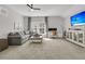 Large bonus room with a gray sectional, a modern ceiling fan, and an entertainment center with a flat screen TV at 3968 Hanoverian Dr, Mount Pleasant, SC 29429
