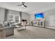 Spacious bonus room with a gray sectional sofa, a large window, and a home office space at 3968 Hanoverian Dr, Mount Pleasant, SC 29429