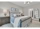 This main bedroom features neutral paint, art, and a king bed with stylish lamps and a walk-in closet at 3968 Hanoverian Dr, Mount Pleasant, SC 29429