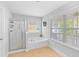 Bright bathroom with a walk-in shower, a soaking tub, and natural light at 408 Branch Creek Trl, Summerville, SC 29483