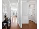 Inviting hallway with hardwood floors, white molding, leading to a bright living area and other rooms at 408 Branch Creek Trl, Summerville, SC 29483