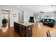Open-concept living space with hardwood floors, leading from the kitchen to a cozy living area with modern decor at 408 Branch Creek Trl, Summerville, SC 29483