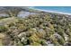 Picturesque aerial view showcasing a lush community nestled among a lake, golf course, and the ocean at 410 Ocean Oaks Ct, Kiawah Island, SC 29455