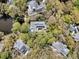 Stunning aerial view of the home and its lush, private surroundings, showcasing the unique architecture at 410 Ocean Oaks Ct, Kiawah Island, SC 29455