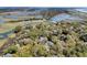 Picturesque aerial view showcasing a lush community nestled among waterways, marshland, and mature trees at 410 Ocean Oaks Ct, Kiawah Island, SC 29455