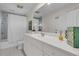 Bright bathroom with white cabinetry, modern fixtures and a shower with tub at 410 Ocean Oaks Ct, Kiawah Island, SC 29455