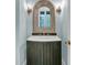 Stylish half-bathroom featuring wainscotting, rustic mirror, and vessel sink vanity at 410 Ocean Oaks Ct, Kiawah Island, SC 29455