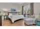 Inviting primary bedroom with french doors, hardwood floors, and a cozy sitting area at 410 Ocean Oaks Ct, Kiawah Island, SC 29455
