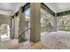 An outdoor patio with stone tile and pillars provides shade from trees at 410 Ocean Oaks Ct, Kiawah Island, SC 29455