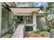 Charming front entrance with stairs, a porch swing, and lush landscaping creating curb appeal at 410 Ocean Oaks Ct, Kiawah Island, SC 29455