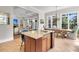 Kitchen with granite island, view to dining and living room, lots of light, and tile flooring at 410 Ocean Oaks Ct, Kiawah Island, SC 29455