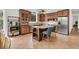 A modern kitchen featuring custom cabinetry, a granite island with seating, and stainless steel appliances at 410 Ocean Oaks Ct, Kiawah Island, SC 29455