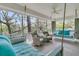 Relaxing screened-in porch with swinging beds and wicker chairs, offering ultimate comfort at 410 Ocean Oaks Ct, Kiawah Island, SC 29455