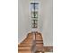 Elegant staircase showcasing hardwood steps, a wooden railing, and natural light from above at 410 Ocean Oaks Ct, Kiawah Island, SC 29455