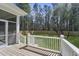 Relaxing backyard view from a deck with white railing and a green lawn surrounded by trees at 4209 Royal Harbor Rd, Hollywood, SC 29449