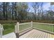 Relaxing backyard view from a deck with a white railing and a green lawn surrounded by trees at 4209 Royal Harbor Rd, Hollywood, SC 29449