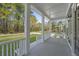 Inviting front porch showcasing classic white columns and scenic neighborhood view at 4209 Royal Harbor Rd, Hollywood, SC 29449