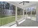 Wide view of the screened porch features a white railing and a green lawn view at 4209 Royal Harbor Rd, Hollywood, SC 29449