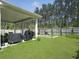 A spacious backyard with a covered patio, a lush lawn, and wooden fencing, perfect for outdoor entertaining at 4310 Cotton Flat Rd, Summerville, SC 29485