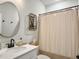 Charming bathroom with unique oval mirror, decor and shower with curtain at 4310 Cotton Flat Rd, Summerville, SC 29485