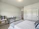 Cozy bedroom featuring a white bed, workspace, and closet storage at 4310 Cotton Flat Rd, Summerville, SC 29485