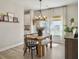 Dining room with wooden table, black chairs, modern chandelier, and stylish decor at 4310 Cotton Flat Rd, Summerville, SC 29485