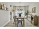 Inviting dining room featuring wood table, black chairs, decor, and natural light from windows at 4310 Cotton Flat Rd, Summerville, SC 29485