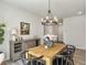 Lovely dining room boasts a wooden table, black chairs, stylish chandelier, and neutral decor at 4310 Cotton Flat Rd, Summerville, SC 29485
