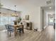 Bright dining room features hardwood floors, modern chandelier, and a large window to the outside at 4310 Cotton Flat Rd, Summerville, SC 29485