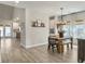 Open-concept dining area with a rustic wooden table, black chairs, and stylish light fixture at 4310 Cotton Flat Rd, Summerville, SC 29485