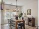 Relaxing dining room with wood table, black chairs, modern chandelier, and sheer curtains at 4310 Cotton Flat Rd, Summerville, SC 29485