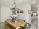 Bright dining area features a wooden table, black chairs, and a modern chandelier at 4310 Cotton Flat Rd, Summerville, SC 29485