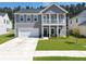 Inviting home exterior featuring a charming front porch and well-maintained lawn at 4310 Cotton Flat Rd, Summerville, SC 29485