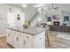 Open-concept view from the kitchen showing the island, fireplace, staircase, hardwood floors, and television at 4310 Cotton Flat Rd, Summerville, SC 29485