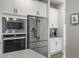 Kitchen features stainless steel refrigerator, built-in microwave and oven, and white cabinets at 4310 Cotton Flat Rd, Summerville, SC 29485