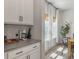 Bright kitchen with white cabinets, countertops, and eat-in dining area at 4310 Cotton Flat Rd, Summerville, SC 29485