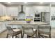 Bright kitchen featuring white cabinets, stainless steel appliances, and an island with bar stool seating at 4310 Cotton Flat Rd, Summerville, SC 29485