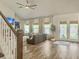Sun-filled living room with hardwood floors, vaulted ceilings, french doors and staircase at 4310 Cotton Flat Rd, Summerville, SC 29485