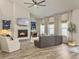 Bright living room featuring hardwood floors, fireplace, and large windows with natural light at 4310 Cotton Flat Rd, Summerville, SC 29485