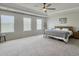 Spacious main bedroom with tray ceilings, ceiling fan, and lots of natural light from multiple windows at 4310 Cotton Flat Rd, Summerville, SC 29485