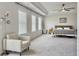Bright main bedroom features neutral decor, ceiling fan, seating area and multiple windows at 4310 Cotton Flat Rd, Summerville, SC 29485