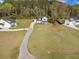 Aerial view features homes with driveways, surrounded by green lawns and mature trees at 4332 John Hatch Dr, Johns Island, SC 29455