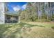 Lush backyard featuring a screened porch extension of the house surrounded by trees at 4332 John Hatch Dr, Johns Island, SC 29455