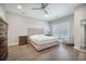 Bright bedroom featuring hardwood floors, neutral walls, and a cozy seating area at 4332 John Hatch Dr, Johns Island, SC 29455