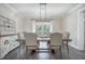 Bright dining room features a wooden table with seating for six and a stylish chandelier at 4332 John Hatch Dr, Johns Island, SC 29455