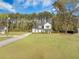 Beautiful home with a large front yard, mature trees, and a long driveway at 4332 John Hatch Dr, Johns Island, SC 29455