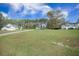 Beautiful home with a sprawling front yard, tree lined street, and separate garage buildings at 4332 John Hatch Dr, Johns Island, SC 29455