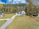 Stunning aerial view of a home with a large yard, mature trees, and a basketball hoop at 4332 John Hatch Dr, Johns Island, SC 29455