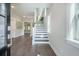Bright and open foyer with hardwood floors and a staircase leading to the upper level at 4332 John Hatch Dr, Johns Island, SC 29455
