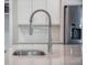 Close-up of a stainless steel gooseneck kitchen faucet set against a white kitchen backdrop at 4332 John Hatch Dr, Johns Island, SC 29455